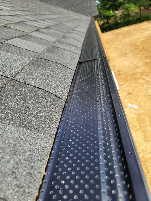 Comparison of gutter guard mesh installed over a K-style gutter in St. Louis
